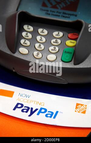 A sign showing that customers can now pay with their PayPal account, sits  at a cashier station at a Home Depot store in Daly City, California,  February 21, 2012. EBay Inc, which owns PayPal, has set a public goal of 20  major retailers testing the point-of-sale ...