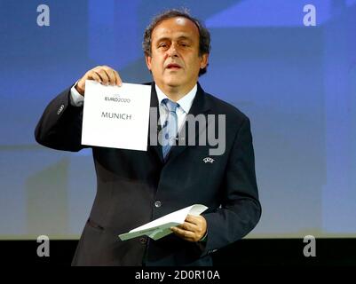 UEFA President Michel Platini shows the name of Munich, one of the 13 cities which will host matches at the Euro 2020 tournament to be played across the continent, during a ceremony in Geneva September 19, 2014.  REUTERS/Pierre Albouy (SWITZERLAND  - Tags: SOCCER SPORT)