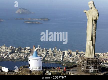 World Wildlife Fund (WWF) members put up a giant faucet in front of the 'Christ the Redeemer' statue, atop Corcovado mountain, during celebrations of World Environment Day in Rio de Janeiro, June 5, 2005.