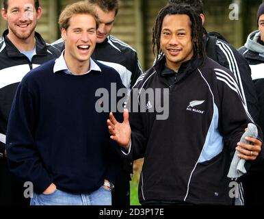 Britain's Prince William (front L) laughs with the captain of the All Blacks Tana Umaga (front R) at a public training session in Auckland July 4, 2005. [Prince William, who graduated recently from Scotland's St Andrews University, met the All Black team two days after they defeated the British and Irish Lions in Wellington and took an unbeatable 2-0 lead in the best-of-three test series.] Prince William is also performing official duties during his ten-day tour of New Zealand, his first official tour of a foreign country by himself.