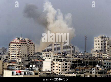 Smoke rises over Gaza after an Israeli warplane attacked the Palestinian police headquarters in the Gaza Strip March 10, 2002. [Israel retaliated on Sunday for a Palestinian suicide bombing that killed 11 Israelis in a Jerusalem cafe by destroying the Gaza headquarters that Yasser Arafat used as a showcase for Palestinian sovereignty.]