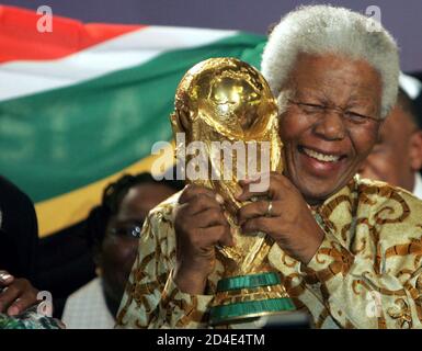 FORMER SOUTH AFRICAN PRESIDENT MANDELA HOLDS TROPHY AFTER SOUTH AFRICA IS CHOSEN TO HOST 2010 WORLD CUP.  Former South African President Nelson Mandela holds the World Cup Trophy after FIFA President Joseph S. Blatter announced that South Africa is chosen to host the 2010 Soccer World Cup in Zurich May 15, 2004. FIFA's Executive committee chose South Africa on the first round of voting ahead of Morocco and Egypt. REUTERS/Andreas Meier