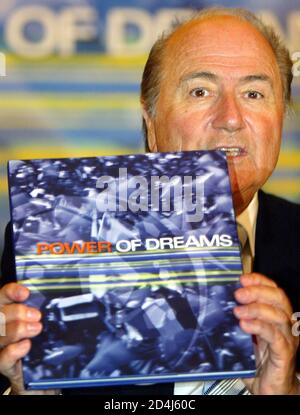 FIFA PRESIDENT BLATTER HOLDS 'THE POWER OF DREAMS - 50 YEARS OF THE ASIAN FOOTBALL CONFEDERATION' IN KUALA LUMPUR.  FIFA President Joseph Blatter holds the newly launched 'The Power of Dreams: 50 Years of the Asian Football Confederation' as he speaks during a news conference in Kuala Lumpur May 7, 2004. The Asian Football Confederation (AFC) on Friday launched the 144-page coffee-table book with 220 images dating from the 1950's, illustrating AFC's history from the beginnings half of a century ago to the house that Asian football is today. REUTERS/Bazuki Muhammad