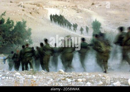 Some One Hundred Israeli Infantry Soldiers Run With Full Military Gear Including Rifles Ammunition And Radio Equipment Through The Jordan Valley Desert As Night Falls December 3 The Soldiers Are On A Training Course And Had Their Faces Darkened As They Ran