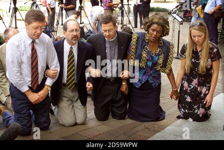 Members of the Christian Defense Coalition pray in front of the Justice Department in Washington, D.C. September 1.  The group first held a press conference to call for an independent investigation of the of the [Clinton administration's ] handling of the 1993 destruction of the Branch Davidian compound in Waco, Texas. From left to right are Randall Terry, Operation Rescue; Rev. Patrick Mahoney, Christian Defense Coalition; Rev. Robert Schenk, National Clergy Council; Rev. Imagene Stewart, African-American Women's Clergy Association; and Brandi Swindell from the American Center for Law and Jus