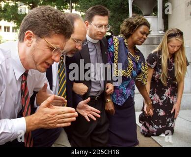Members of the Christian Defense Coalition pray in front of the Justice Department in Washington, D.C. September 1. The group first held a press conference to call for an independent investigation of the of the Clinton administration's handling of the 1993 destruction of the Branch Davidian compound in Waco, Texas. From left to right are Randall Terry, Operation Rescue; Rev. Patrick Mahoney, Christian Defense Coalition; Rev. Robert Schenk, National Clergy Council; Rev. Imagene Stewart, African-American Women's Clergy Association; and Brandi Swindell from the American Center for Law and Justice