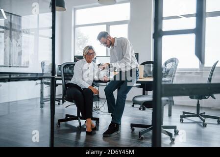 Dos corredores de bolsa en ropa formal trabaja en la oficina con mercado financiero Foto de stock