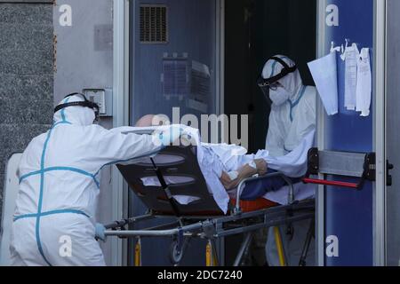 Paramedicals lleva un paciente con camilla Coronavirus COVID-19, para llevarlo al hospital Antonio Cardarelli donde será tratado. Foto de stock