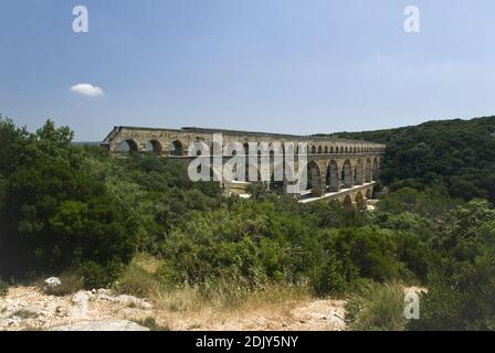 The Pont du Gard is an ancient Roman aqueduct that crosses the Gardon River, Vers-Pont-du-Gard, near Remoulins, in Provence, France. Stock Photo