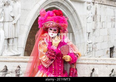 Mujer vestida con un traje tradicional decorado y una máscara pintada durante el Carnaval de Venecia en Venecia, Italia Foto de stock
