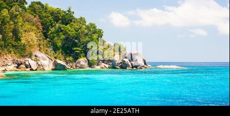Paisaje de las islas Similan en verano soleado, agua de mar turquesa cristalina contra las islas tropicales, nubes blancas y fondos de cielo azul. Tailandia. Foto de stock