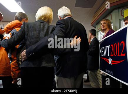 U.S. Republican presidential candidate and former Speaker of the House Newt Gingrich (centre, R) and his wife Callista pose for pictures at the National Farm Toy Museum during a campaign stop in Dyersville, Iowa, December 27, 2011. REUTERS/Jim Young      (UNITED STATES - Tags: POLITICS)