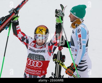 Felix Neureuther de Alemania (R) camina detrás como Marcel Hirscher de Austria celebra después de ganar el Slalom gigante de la Copa Mundial de esquí Alpino para hombres en Garmisch-Partenkirchen 1 de marzo de 2015. REUTERS/Wolfgang Rattay (ALEMANIA - Tags: ESQUÍ DEPORTIVO)