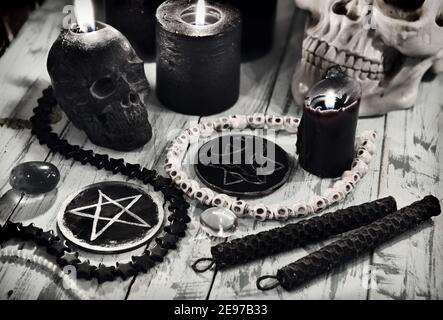 Pentagrama y símbolos del diablo con velas negras encendidas en la mesa de  madera de bruja. Fondo esotérico, gótico y oculto, concepto místico de  Halloween Fotografía de stock - Alamy