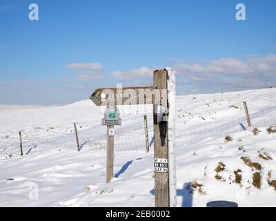 Pennine Way signo en madera poste cubierto de nieve páramos y.. cielo azul