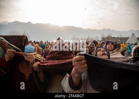 Srinagar, India. 19th de marzo de 2021. Las devotos de las mujeres de Cachemira levantan las manos mientras asedian bendiciones como el sacerdote principal (no enmarcado) Muestra reliquia que se cree que proviene de la barba del Profeta Muhammad durante la celebración.devotos de todo Cachemira atronaron el venerado santuario Hazratbal para las oraciones congregacionales y para tener una visión de la reliquia Santa del Profeta Islámico Muhammad en la ocasión siguiente de Meraj-ul-Alam (ascensión al cielo) en Srinagar. (Foto de Imrees Abbas/SOPA Images/Sipa USA) crédito: SIPA USA/Alamy Live News Foto de stock