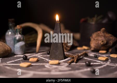 Pentagrama y símbolos del diablo con velas negras encendidas en la mesa de  madera de bruja. Fondo esotérico, gótico y oculto, concepto místico de  Halloween Fotografía de stock - Alamy