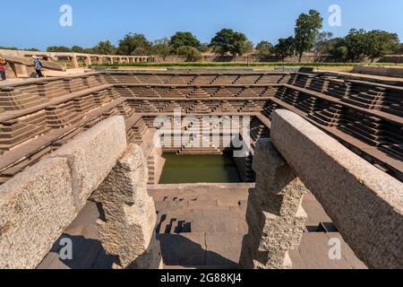 Hampi, Karnataka, India - 14 de enero de 2020 : tanque de agua cuadrado simétrico escalonado (estepwell) dentro del recinto real en Hampi. Foto de stock