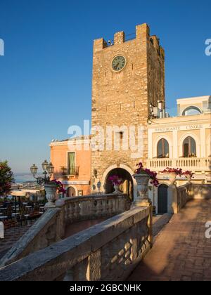 Taormina, Messina, Sicilia, Italia. Vista desde la terraza de la Iglesia de San Giuseppe cruzando la Piazza IX Aprile hasta la Torre dell'Orologio, amanecer. Foto de stock