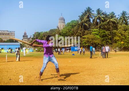 Mumbai, Maharashtra, India : Un joven juega cricket en el parque Oval Maidan en el distrito de Churchgate. Foto de stock