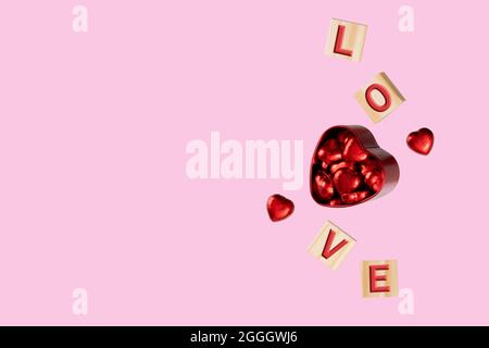 Cubos en relieve con letras L-O-V-E flotando alrededor de una caja roja de estaño llena de caramelos de chocolate en láminas rojas brillantes. Fondo rosa suave. Foto de stock
