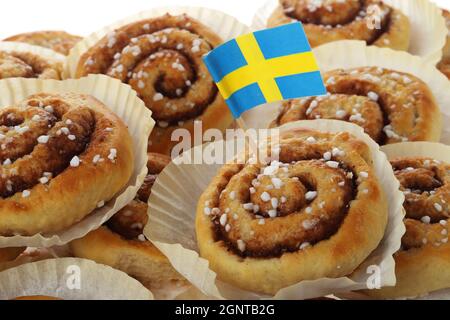 Rollitos de canela tradicionales decorados con una bandera sueca. Foto de stock