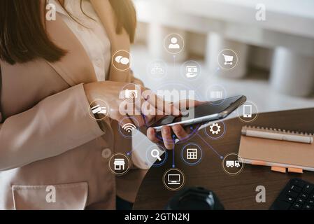 Medios sociales y marketing Iconos virtuales Pantalla de mujeres de negocios tecleando teclado con teléfono inteligente.