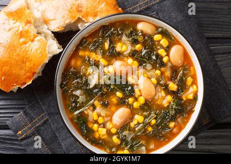 ¿Kara lahana corbas? sabrosa sopa de col rizada con col rizada, frijoles y maíz en un bol sobre la mesa. Vista superior horizontal desde arriba