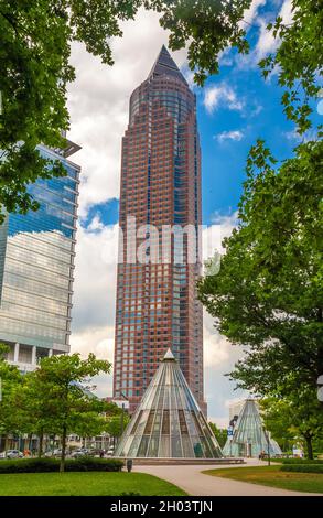 Vista pintoresca del famoso Messeturm, o la Torre del Recinto Ferial, un rascacielos en el distrito Westend-Süd de Frankfurt, Alemania visto desde el parque... Foto de stock