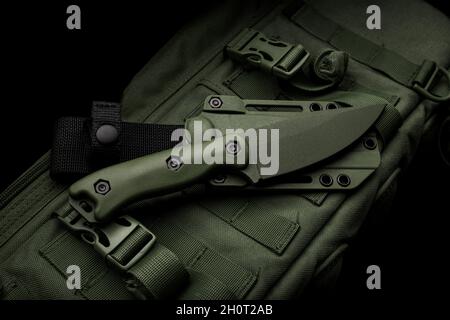 Un cuchillo militar moderno y una funda de plástico para él las