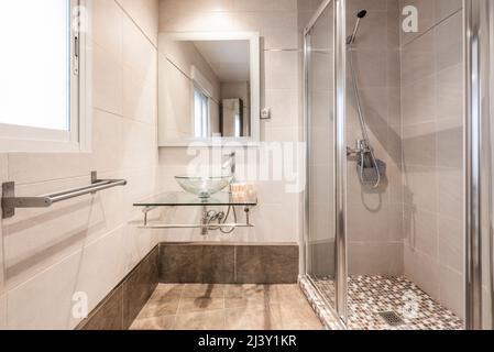 Bañera y cabina de ducha con azulejos y pared de cristal situada en el  moderno cuarto de baño durante el día en casa Fotografía de stock - Alamy