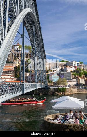 Puente Luís I (Ponte Luís I) cruzando el río Duero con restaurante y barco de placer, Oporto, Portugal, Europa Foto de stock