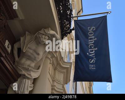 Vista en ángulo bajo de la entrada del edificio de la casa de subastas Sotheby's en el centro histórico de Viena, Austria con bandera azul con logotipo.