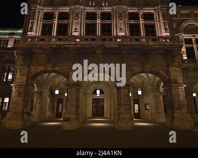 Vista frontal de la entrada del lado este de la famosa Ópera Estatal de Viena en el centro histórico de Viena, Austria por la noche con faroles. Foto de stock