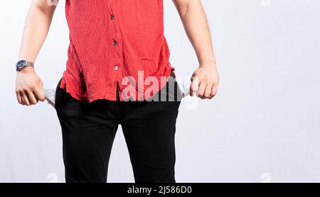 Concepto de un hombre sin dinero, hombre mostrando sus bolsillos vacíos, cerca de un bolsillo de pantalones vacíos Foto de stock