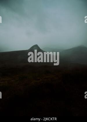 Un paisaje de montaña nublado, oscuro y árido en las Tierras Altas de Escocia, un paisaje oscuro y malhumorado de fondo Foto de stock