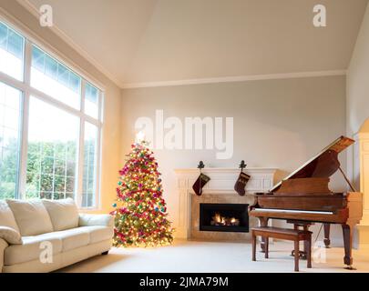 Sala de estar decorada con árbol de Navidad y medias colgantes en la chimenea durante el día