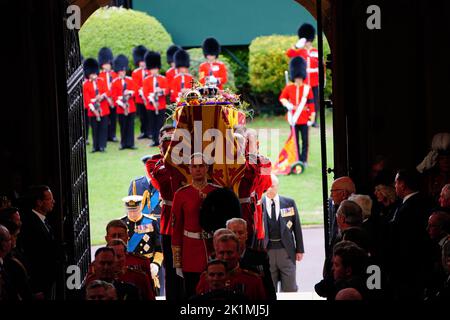 El rey Carlos III (izquierda) sigue como los portadores del ataúd llevan el ataúd de la Reina Isabel II a la Capilla de San Jorge en el Castillo de Windsor, Berkshire, para el Servicio de Compromiso. Fecha de la foto: Lunes 19 de septiembre de 2022. Foto de stock