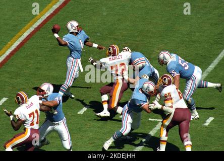 Houston Oilers quarterback Warren Moon sits dejectedly on the