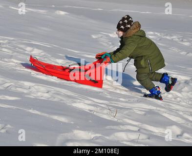 YICHUN, CHINA - 9 DE DICIEMBRE de 2022 - Los niños juegan en la nieve en la ciudad de Yichun, provincia de Heilongjiang, China, 9 de diciembre de 2022. A medida que China optimizó aún más el Foto de stock