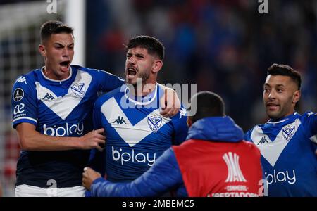 Nicolas Garayalde of Argentina's Velez Sarsfield, left, heads the ball as  Guillermo Varela of Brazil's Flamengo looks on during a Copa Libertadores  semifinal second leg soccer match at Maracana stadium in Rio