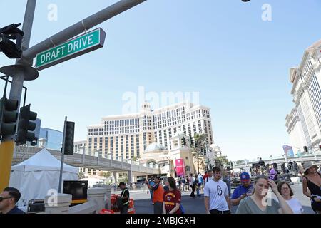 Fans walk underneath a Draft Drive ceremonial street sign on Thursday, April 28, 2022, in Las Vegas. The corner of Las Vegas Blvd. and Flamingo was temporarily renamed for the NFL Draft being held April 28-30. (AP Photo/Gregory Payan)