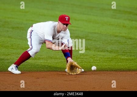 Texas Rangers third baseman Brock Holt (16) blows a bubble during a  baseball game against the