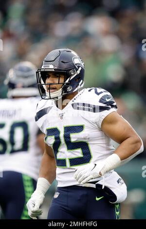 Seattle Seahawks running back Travis Homer (25) toplles over Pittsburgh  Steelers safety Tre Norwood (21) on a run during the first half of an NFL  preseason football game, Saturday, Aug. 13, 2022