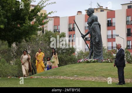 People wait by the statues of Mahatma Gandhi and his wife Kasturba at the Radha Krishna Temple before the visit by India's Prime Minister Narendra Modi in Lisbon, Portugal, Saturday June 24, 2017. Modi is on a one day visit to Portugal. (AP Photo/Armando Franca)