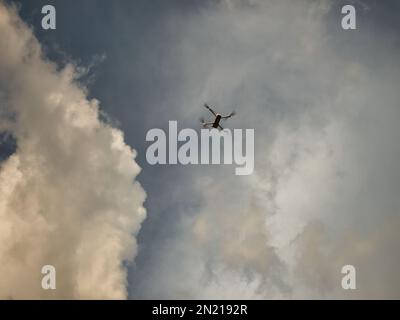 Un quadcopter con una cámara incorporada vuela hacia el cielo, captura imágenes de vídeo de la foto Foto de stock
