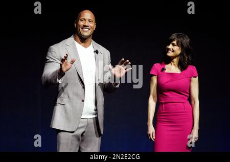 FILE - In this Tuesday, April 21, 2015 file photo, Dwayne Johnson, left, a cast member in the upcoming film 'San Andreas,' and fellow cast member Carla Gugino introduce a clip from the film during CinemaCon 2015 at Caesars Palace, in Las Vegas. Warner Bros. will evaluate the worldwide marketing campaign for its upcoming earthquake film “San Andreas” in light of the Nepal earthquake, the studio said Wednesday, April 29, 2015. (Photo by Chris Pizzello/Invision/AP, File)