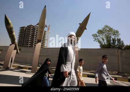 Iranian cleric Mohammad Kalbasi and his family visit an exhibition on the 1980-88 Iran-Iraq war, at a park, northern Tehran, Iran, Thursday, Sept. 25, 2014. Iran begun a week of celebration starting Monday called 'Sacred Defense Week' to mark the 34th anniversary of the outset of its war with Iraq which imposed by the Iraqi dictator Saddam Hussein that left about a million casualties on both sides. (AP Photo/Vahid Salemi)
