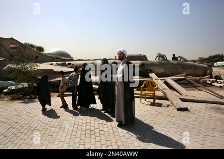 Iranian cleric Mohammad Kalbasi and his family visit an exhibition on the 1980-88 Iran-Iraq war, at a park, northern Tehran, Iran, Thursday, Sept. 25, 2014. Iran begun a week of celebration starting Monday called 'Sacred Defense Week' to mark the 34th anniversary of the outset of its war with Iraq which imposed by the Iraqi dictator Saddam Hussein that left about a million casualties on both sides. (AP Photo/Vahid Salemi))