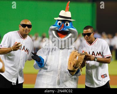 Former MLB pitchers Livan Hernandez, left, and his half-brother Orlando   El Duque Hernandez, right, chat with Jacob Forever, former member of the  Cuban reggaeton group Gente de Zona, after throwing out